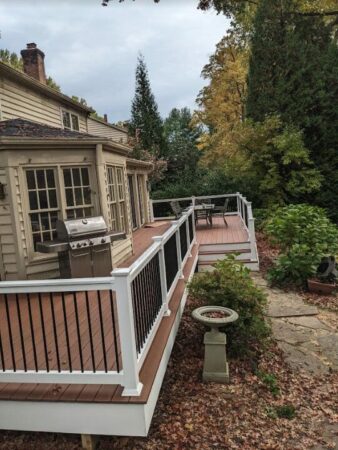 new deck with composite boards and white rails and black railings
