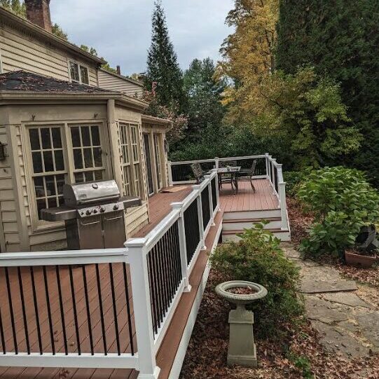 new deck with composite boards and white rails and black railings